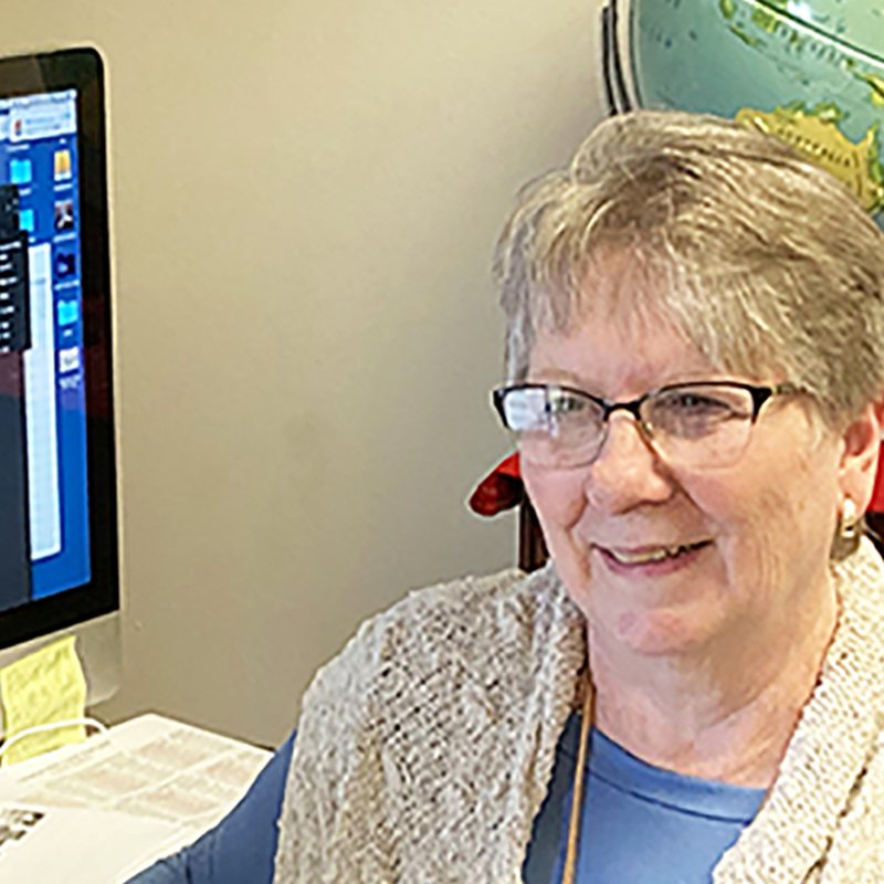 Malinda Harrison, graphic design director at International Christian Publishers, at her design workstation.